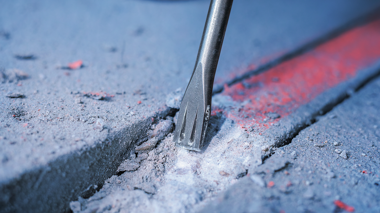 표시된 선을 따라 콘크리트를 부수는 끌 비트입니다.