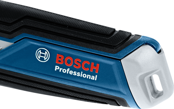 질감이 있는 그립이 달린 파란색과 검은색 전동 공구 손잡이의 클로즈업.